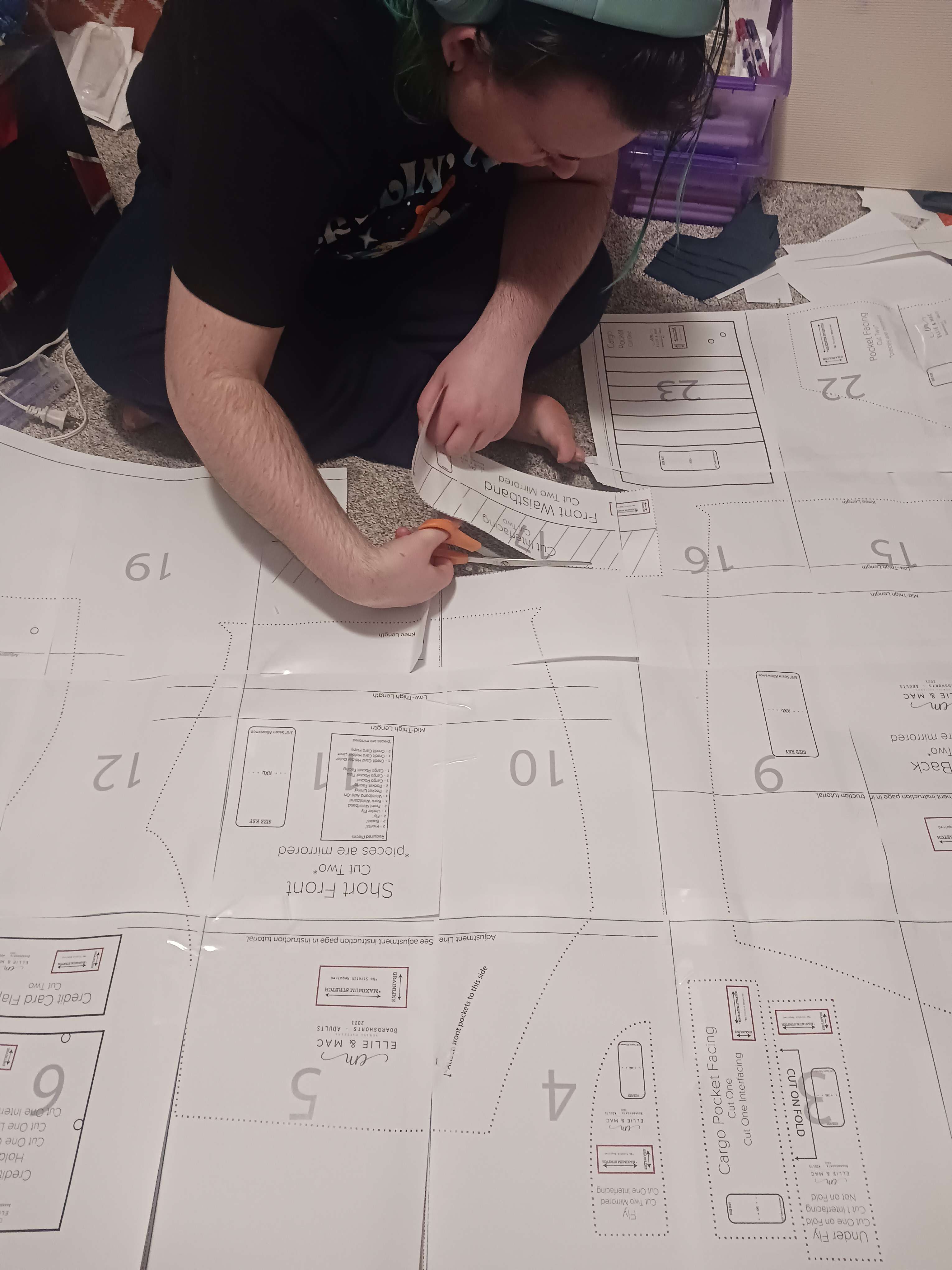 Me cutting out a sewing pattern