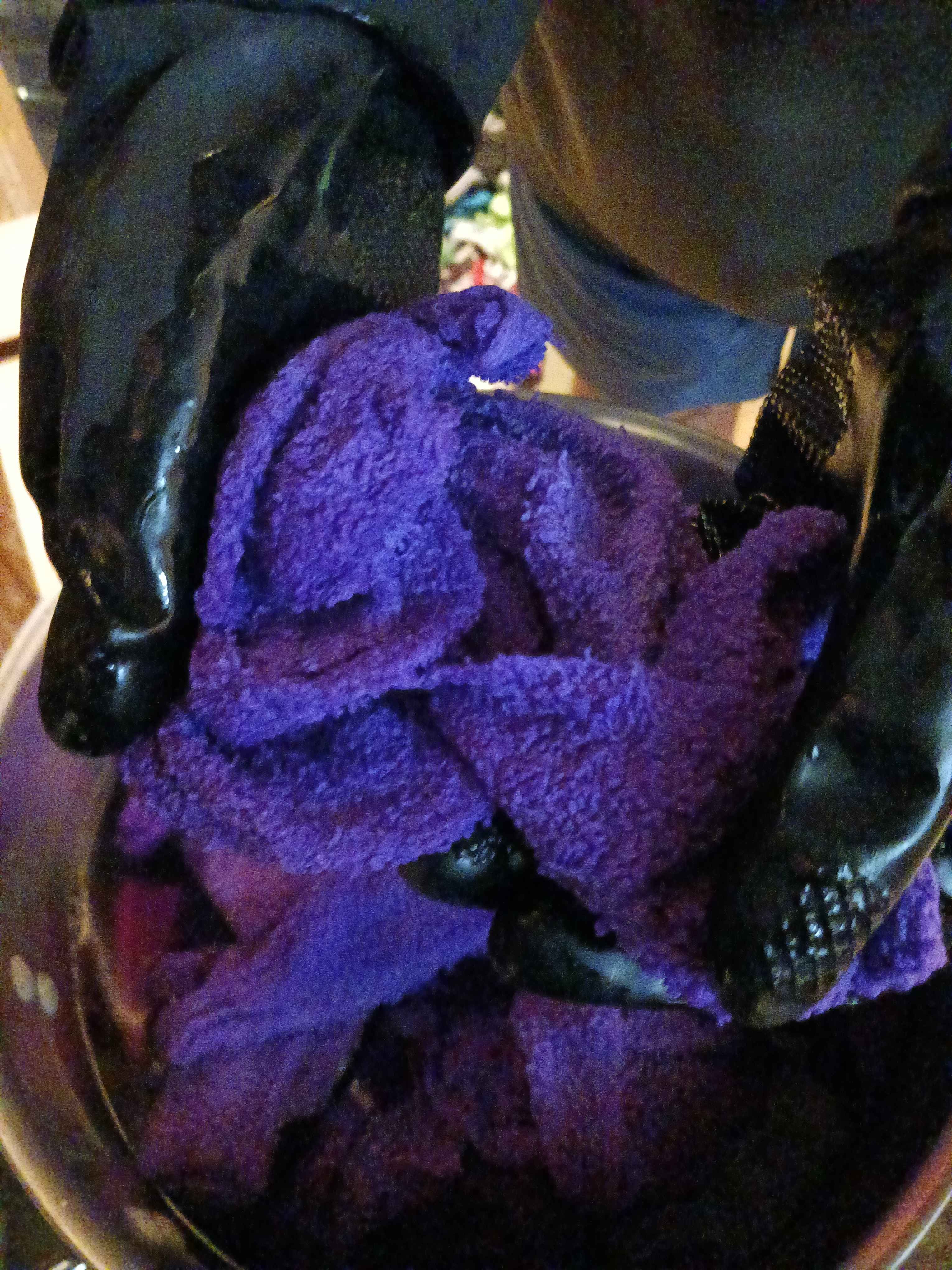my (gloved) hands holding some of the fabric out of the soup