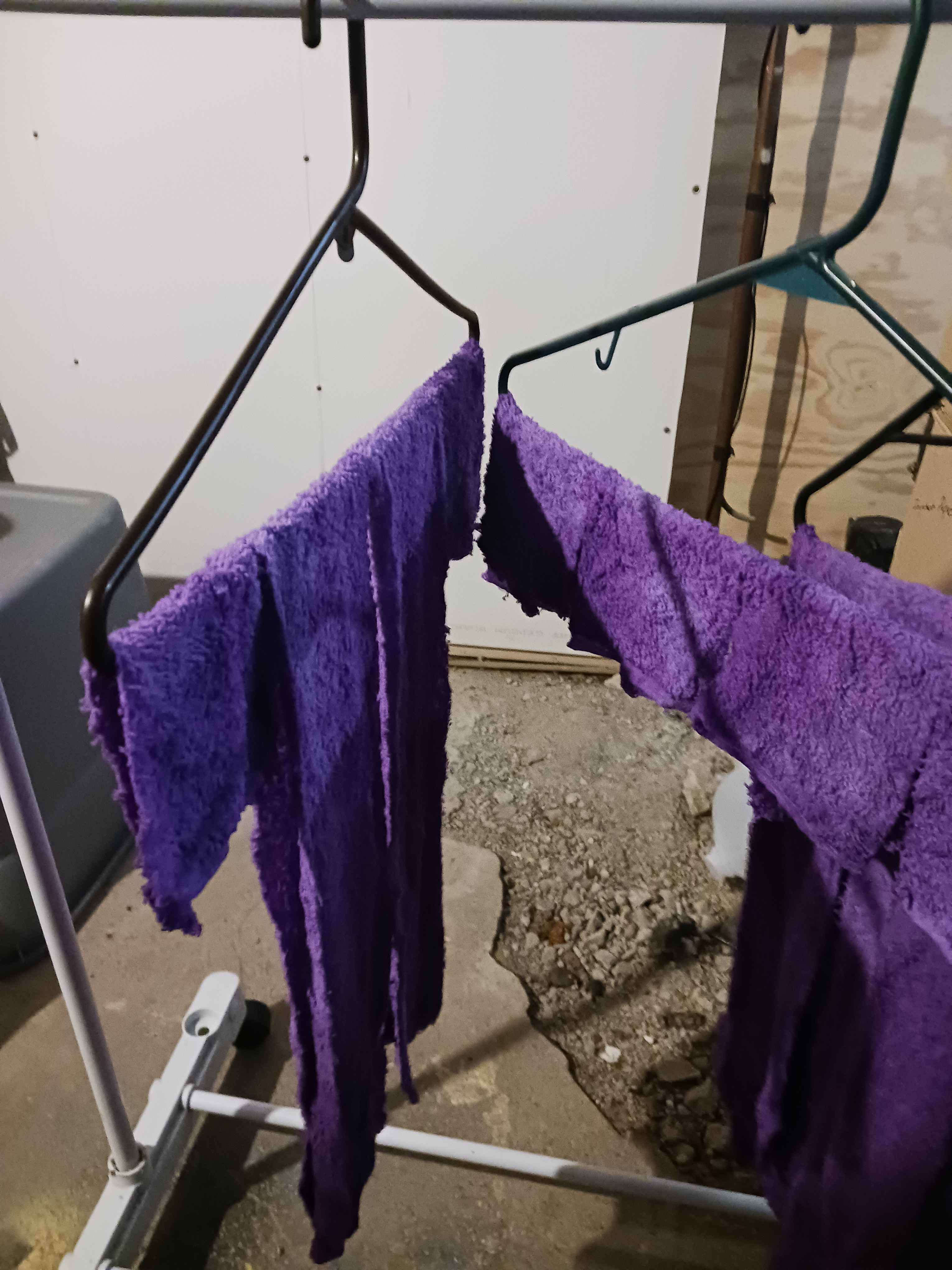 dyed strips of fabric hanging off of hangers