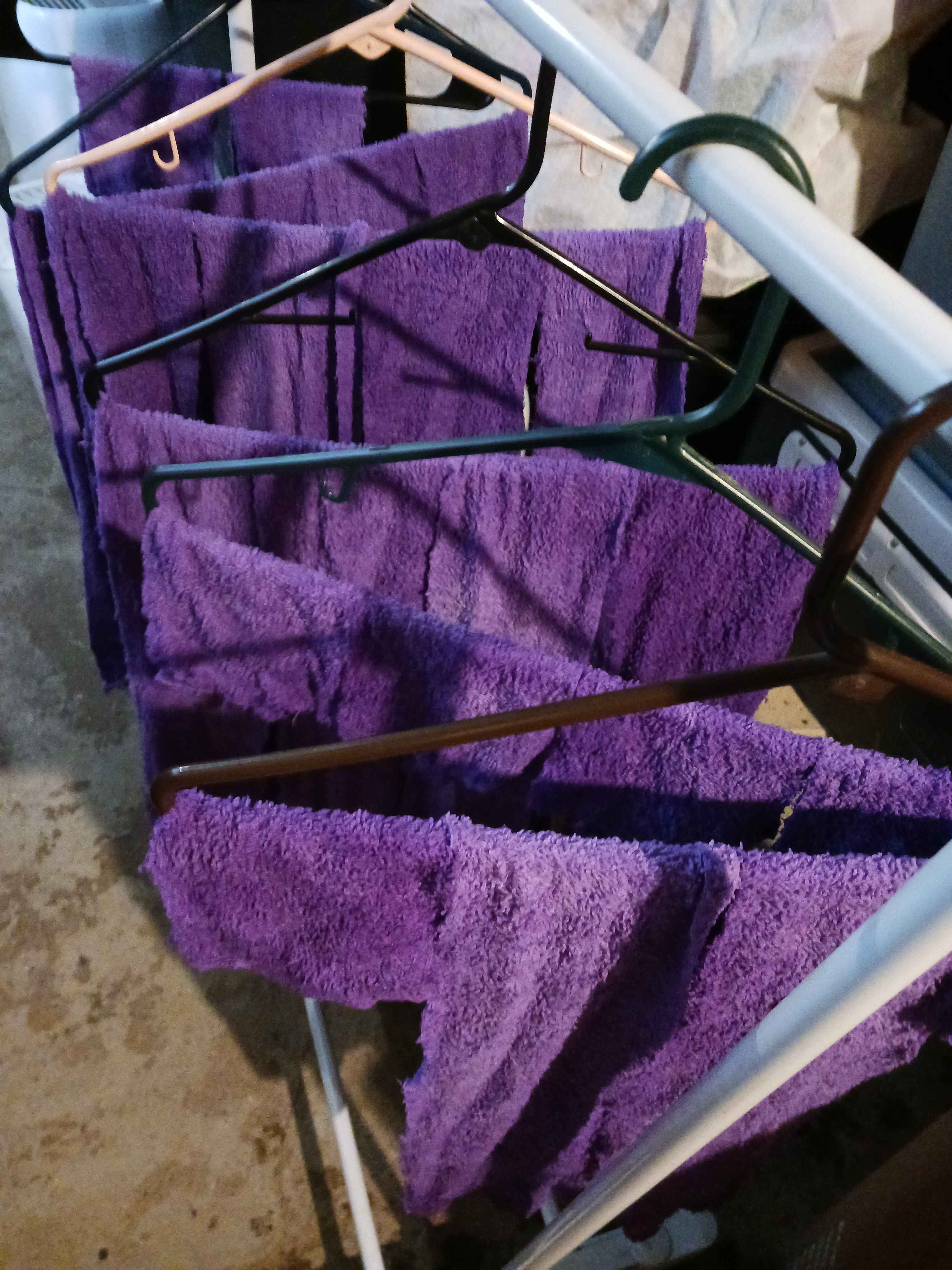 more dyed strips of fabric hanging off hangers