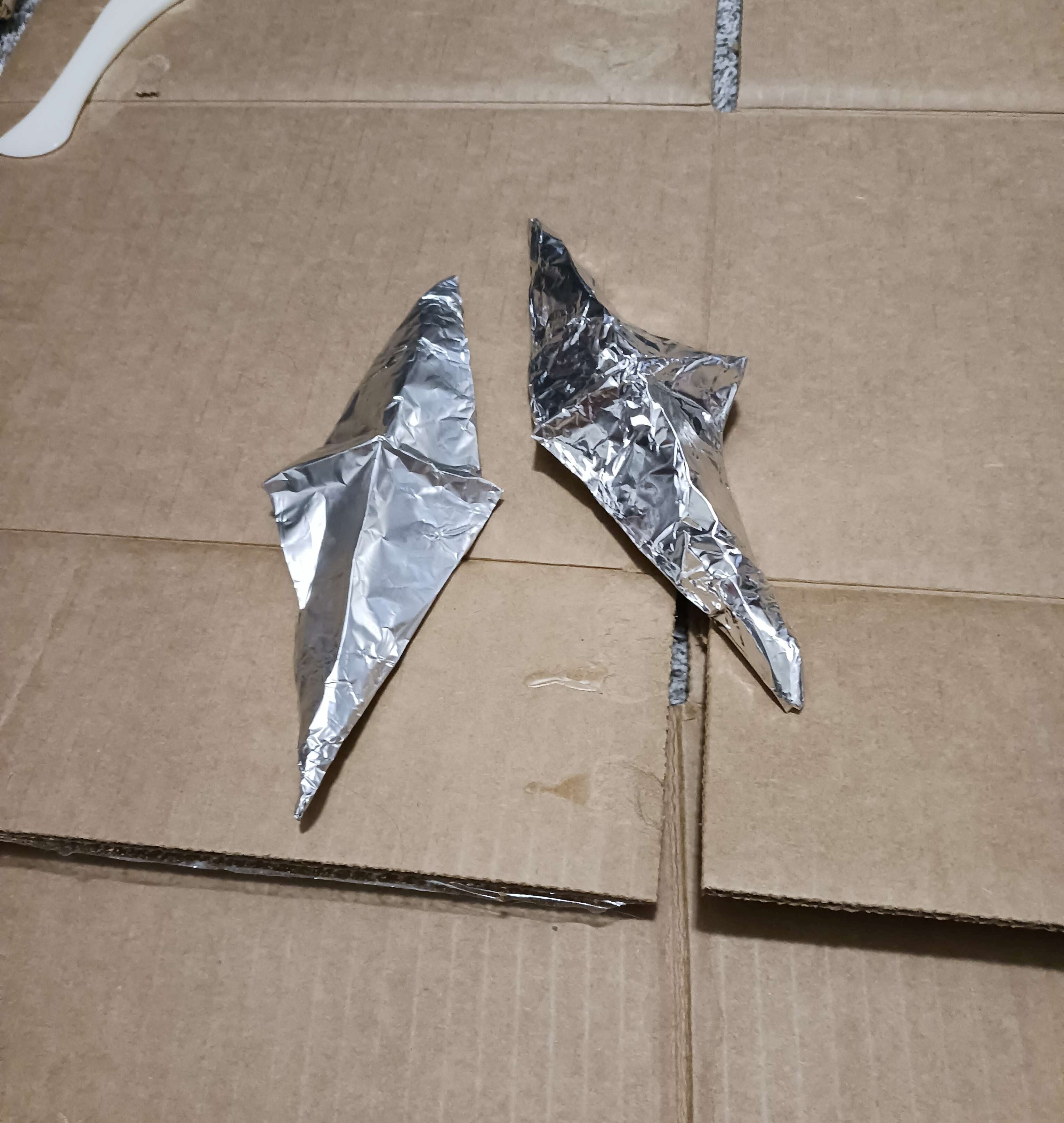 two diamond-shaped bits on tin foil